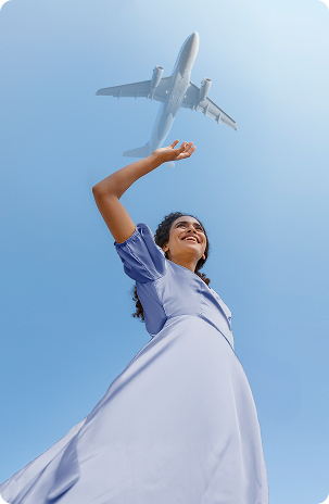 Person reaching for airplane in sky