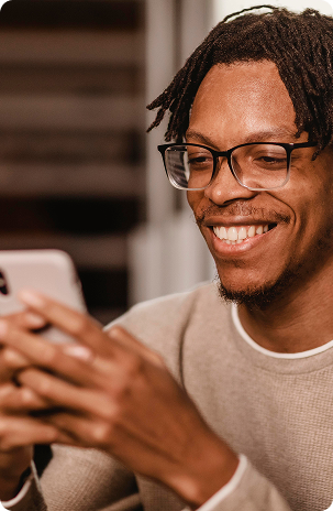 Man smiling while looking at device